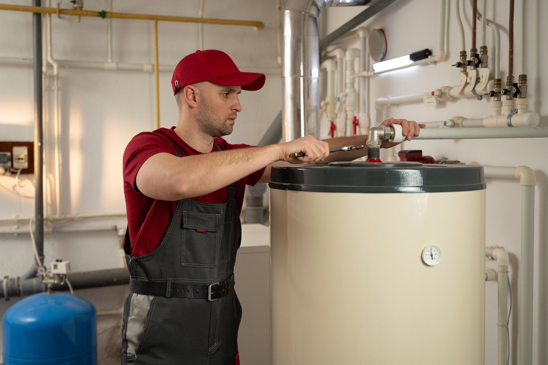 Man in Red Shirt Fixes Water Heater